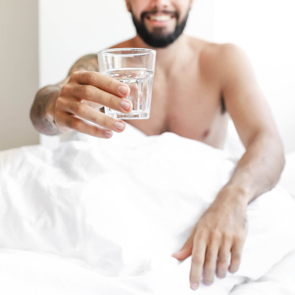 morning man-showing-glass-water