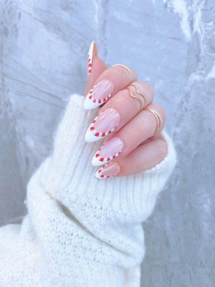 Modern winter almond nails in candy cane french nails