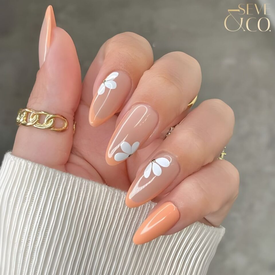 Peach nude Almond nails with minimalistic Flowers